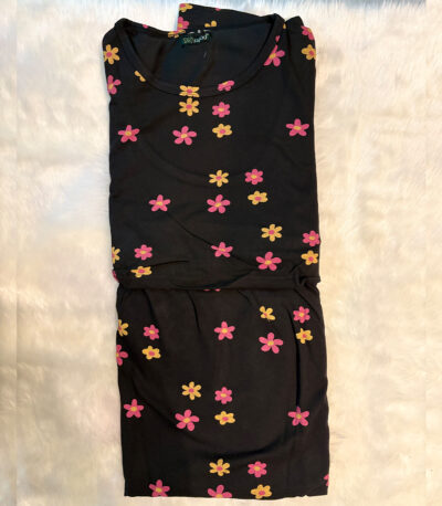 A cozy lounge dress in black with lively pink and mustard floral prints. Soft, breathable, and made for relaxed charm.